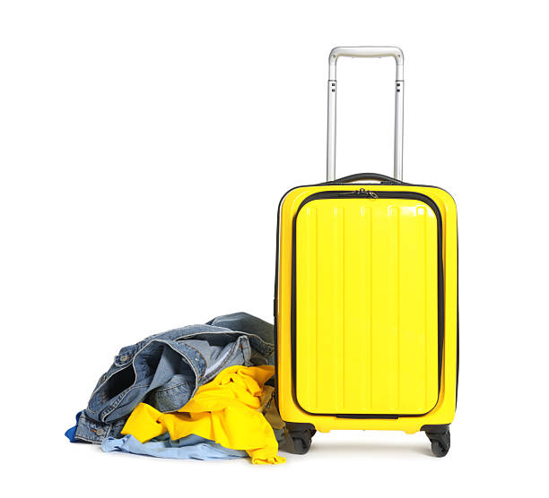 istock Suitcase and messy pile of clothes isolated on white 2242725250