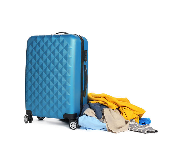 istock Suitcase and messy pile of clothes isolated on white 2242725251