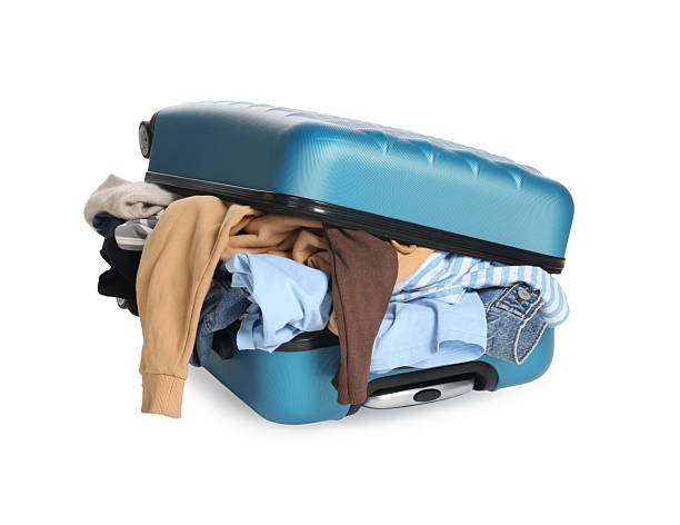 istock Packed suitcase full of clothes isolated on white 2242725253