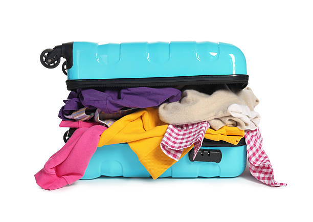 istock Packed suitcase full of clothes isolated on white 2242725271