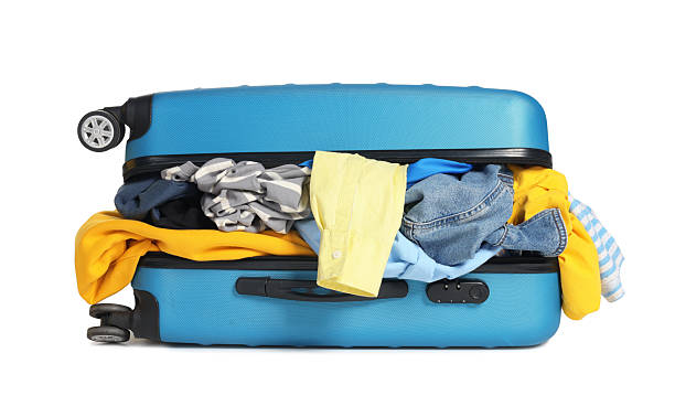 istock Packed suitcase full of clothes isolated on white 2242725276