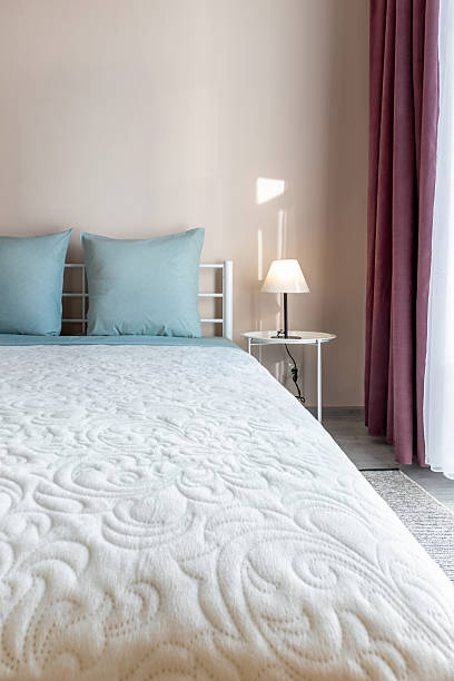 istock Minimal Bedroom Interior with Blue Pillows and Soft White Bedspread 2242728949