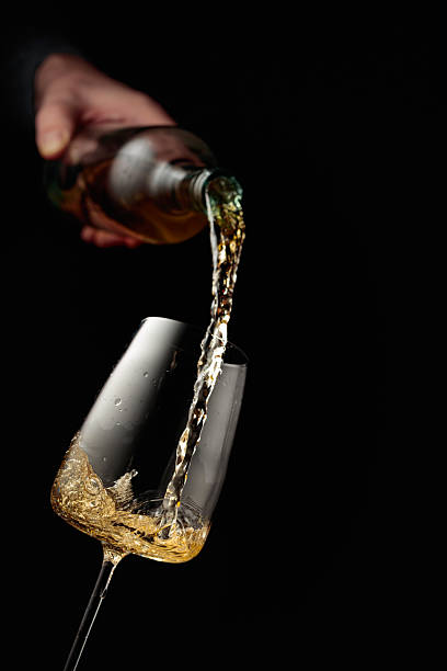 istock Pouring white wine in a glass. 2242729558