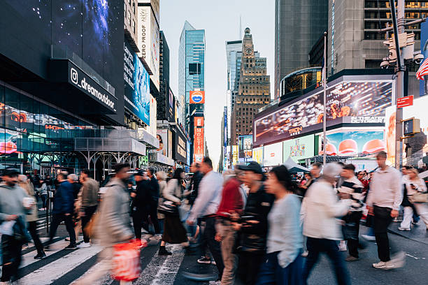 istock People walking through crowded Times Square surrounded by lights and advertisements 2242729969