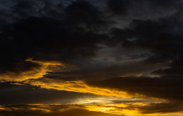 istock Dark clouds glowing gold at sunset, Wirral, Merseyside, England, Britain 2242733021