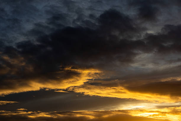 istock Dark clouds glowing gold at sunset, Wirral, Merseyside, England, Britain 2242733056
