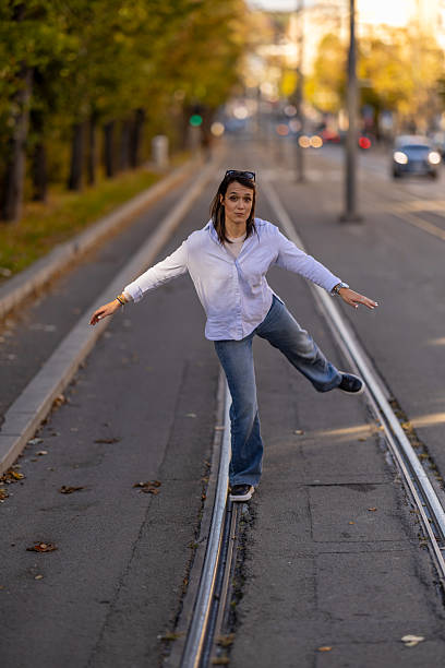 istock girl balancing on rails in city 2242735507