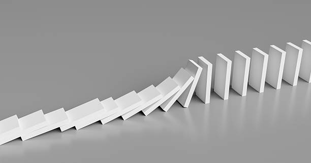 istock The Domino Effect: White Dominoes Toppling in a Chain Reaction on a Grey Background. 3d rendering 2242740740