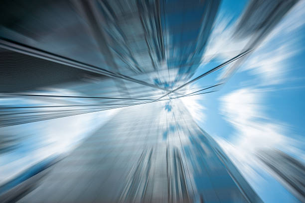 istock Abstract image of Hong Kong architectures captured with a radial blur effect, creating a dynamic, modern feel. The sky peeks through the buildings. 2242743556