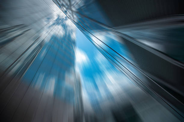 Abstract image showcases Hong Kong architectures through a radial blur effect. Dynamic composition captures the city's essence. Sky visible.