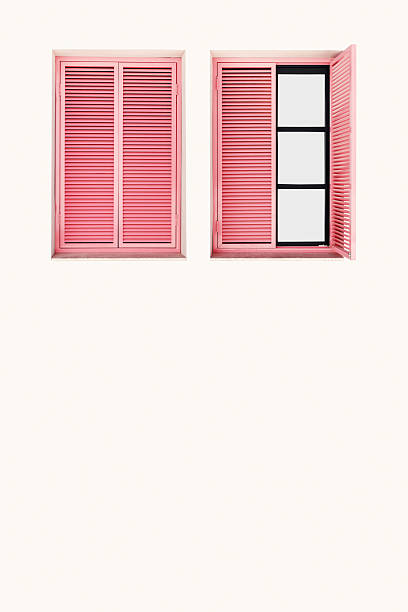 istock Two Beautiful wooden Windows frames on light beige wall with pink shutters, home facade design with soft shadow. Minimal pastel aesthetics, retro style summer travel backgrounds, vertical copy space 2242744744
