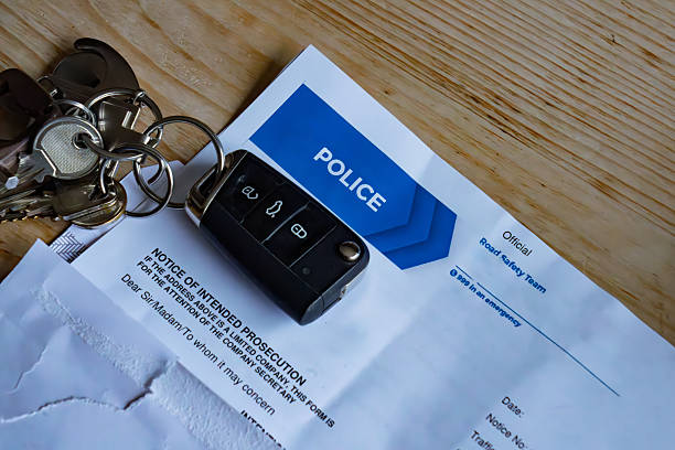 istock Car key fob and speeding fine documents arranged on flat surface for administrative review 2242744782