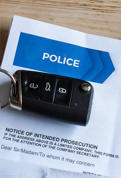 Car key fob and speeding fine documents arranged on flat surface for administrative review