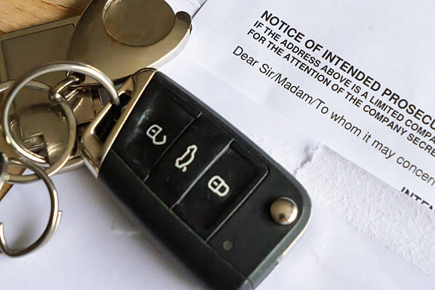 istock Car key fob and speeding fine documents arranged on flat surface for administrative review 2242744964