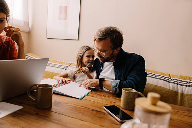 istock Family at home studying together with child 2242747951