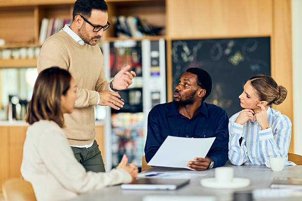 African-American Man Leads Discussion With Team During Collaborative Office Meeting In Modern Space