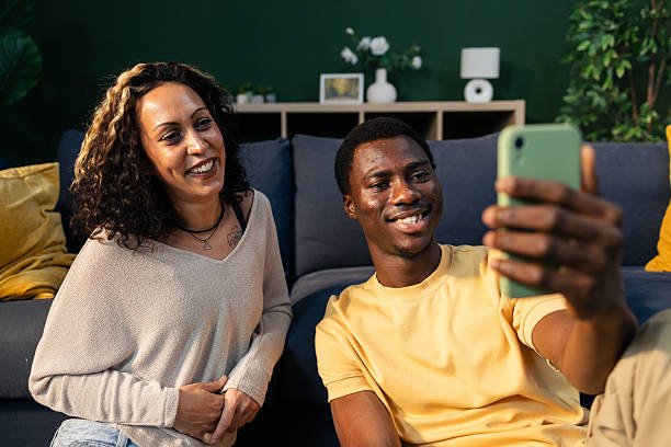 istock Happy diverse couple taking selfie with smartphone at home 2242749138