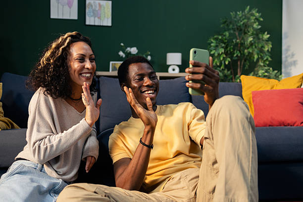 istock Diverse couple having video call on smartphone at home 2242749143