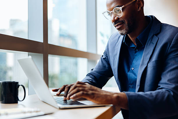 istock Confident professional man working on a laptop in a bright office setting 2242749277
