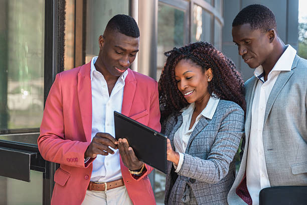 istock Diverse multiracial Business team using a digital tablet outdoors and discussing about a new project 2242749418