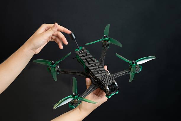 istock Professional modern drone with digital camera in hand on black background 2242750504