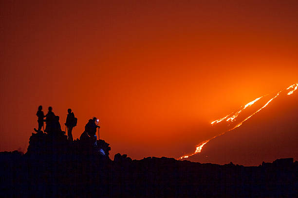 istock Group of hikers contemplate lava flow 2242751017