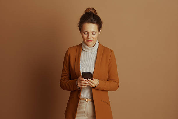 istock Focused Woman Engaging with Smartphone 2242753371