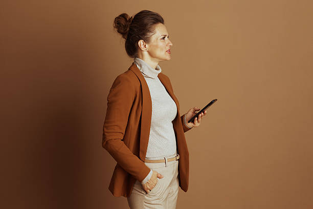 istock Sophisticated Woman Engaged with Smartphone in Profile 2242753373