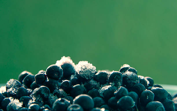 close-up of the ripe blueberries covered with ice lying on a plate