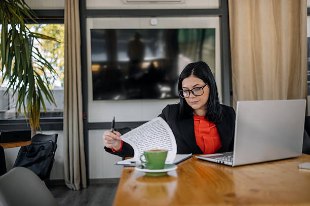 istock Young businesswoman working using wireless technology while sitting at cafe taking a coffee break 2242753741