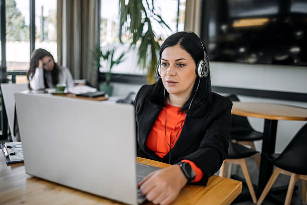 istock Young businesswoman working using wireless technology while sitting at cafe taking a coffee break 2242753759