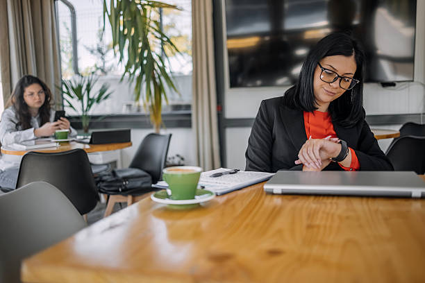 istock Young businesswoman working using wireless technology while sitting at cafe taking a coffee break 2242753812