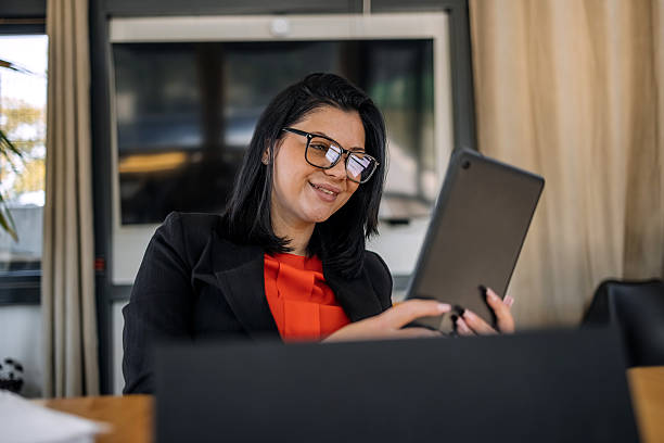 istock Young businesswoman working using wireless technology while sitting at cafe taking a coffee break 2242753965