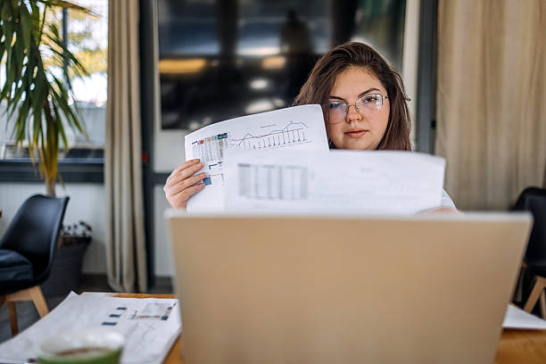 istock Young businesswoman working using wireless technology while sitting at cafe taking a coffee break 2242754161