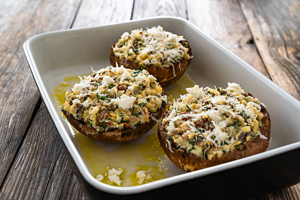 istock Stuffed portobello mushrooms in baking dish ready for baking on wooden table 2242755617
