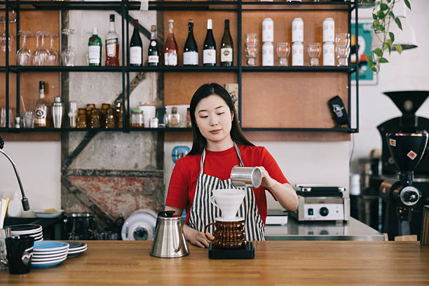 istock Barista preparing a pour-over coffee in a trendy cafe setting 2242758153