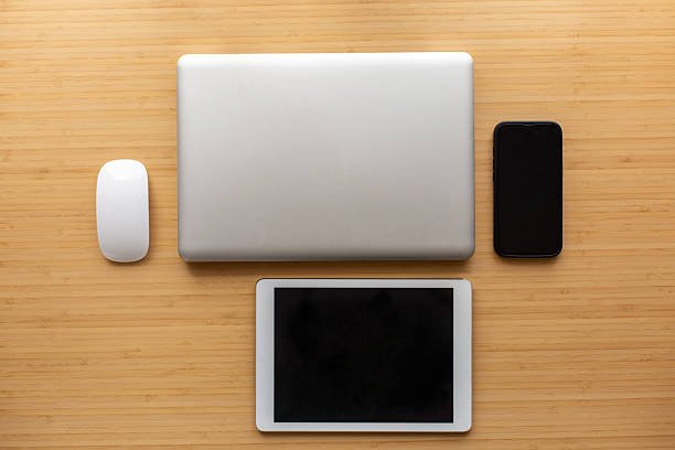 electronic devices and notebook on white table surface