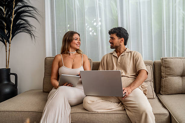 istock Casual Couple On Sofa Using Laptop And Tablet At Home for Valentine's Day 2242760215