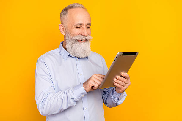 istock Portrait of attractive cheerful focused man using device typing chatting isolated over gray pastel color background 2242762954