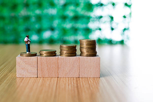 istock Coins on toy block and figurine 2242763176