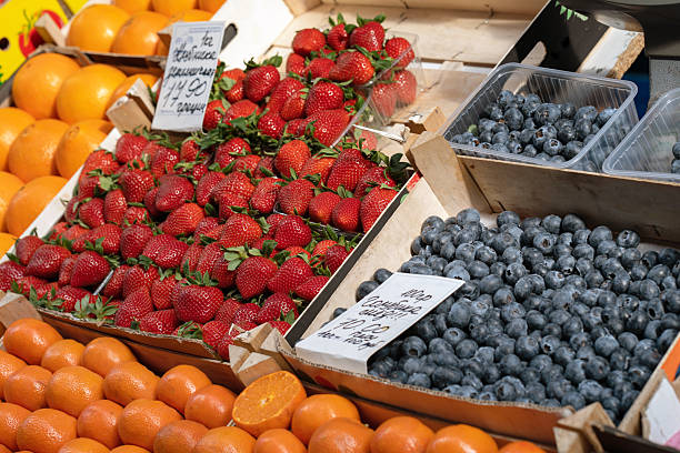 istock Strawberries and blueberries on a market stall. 2242763972