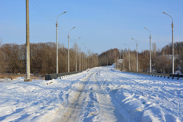 Snow-covered winter road lined with streetlights