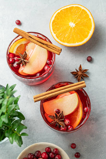 istock A cranberry drink in a two glasses on a light background with cinnamon, berries and citrus fruit. 2242765715
