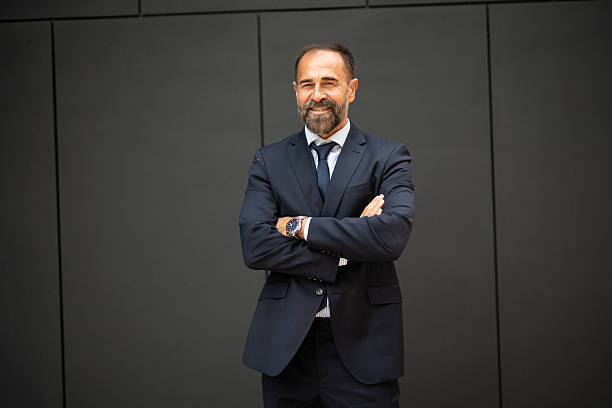 istock Confident businessman standing with arms crossed smiling 2242765746
