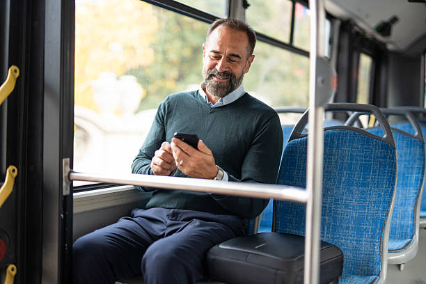 istock Mature adult man smiling using phone while commuting 2242766545
