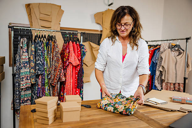 istock Senior Female Retailer Folding Dress For Packaging 2242770869