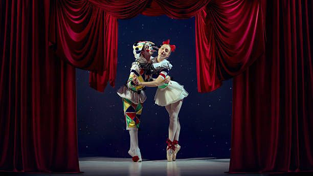istock Emotive composition. Mime and ballerina embracing on stage for lighting reference. 2242771189