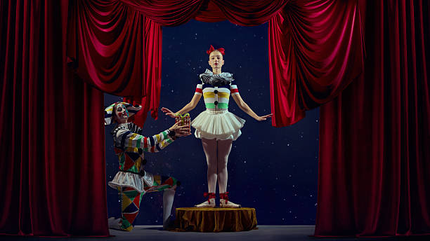 istock Gift of performance. Mime presenting small box to ballerina on stage. 2242771220