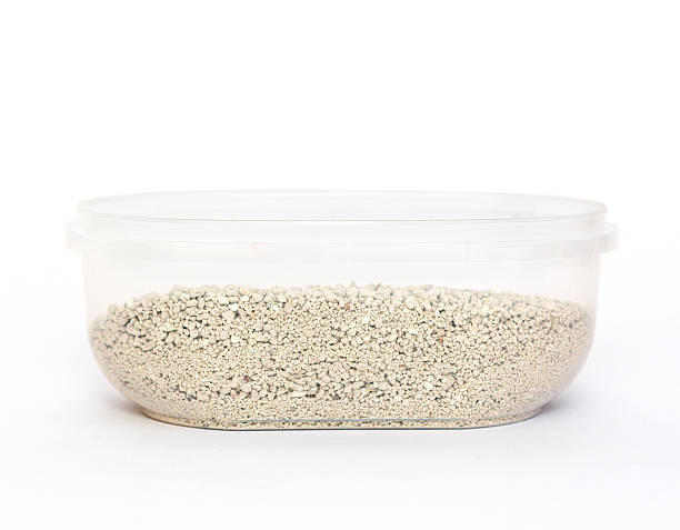 Transparent container holds fine white small granules of cat litter, emphasizing a clean aesthetic and functional design, suitable for storage and organization in various settings Pet care.