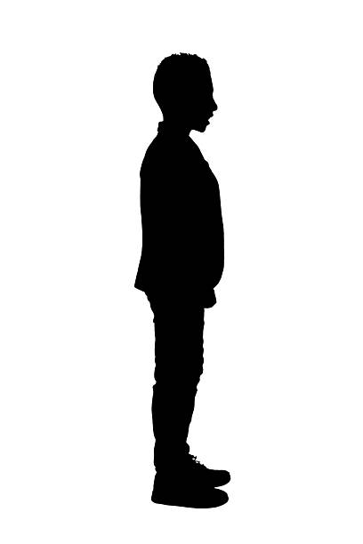 istock silhouette of a side view of a boy standing  dressed with jacket on white background 2242779193